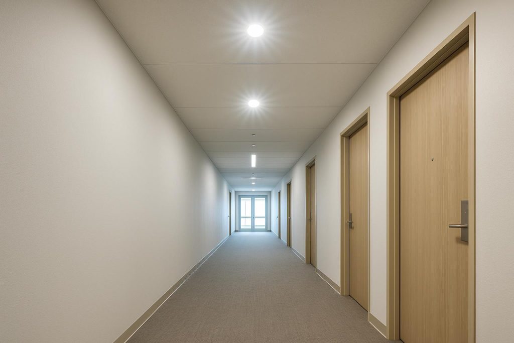 Overhead emergency lighting in a corridor illustrating Alberta’s legal safety requirement.